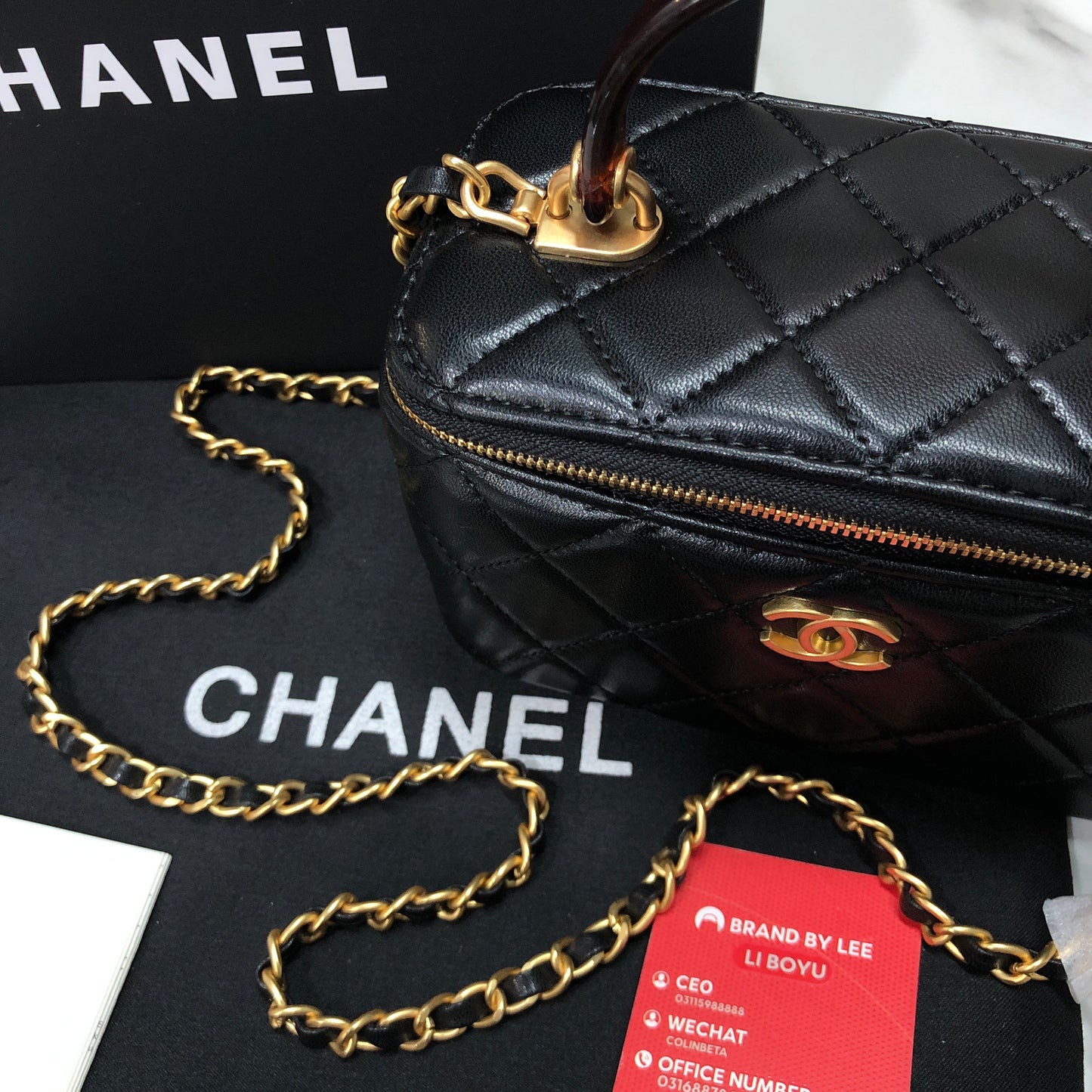Chanel Quilted Lambskin Vanity Case with a top handle